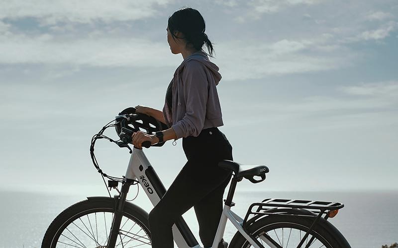 a woman holding a bicycle